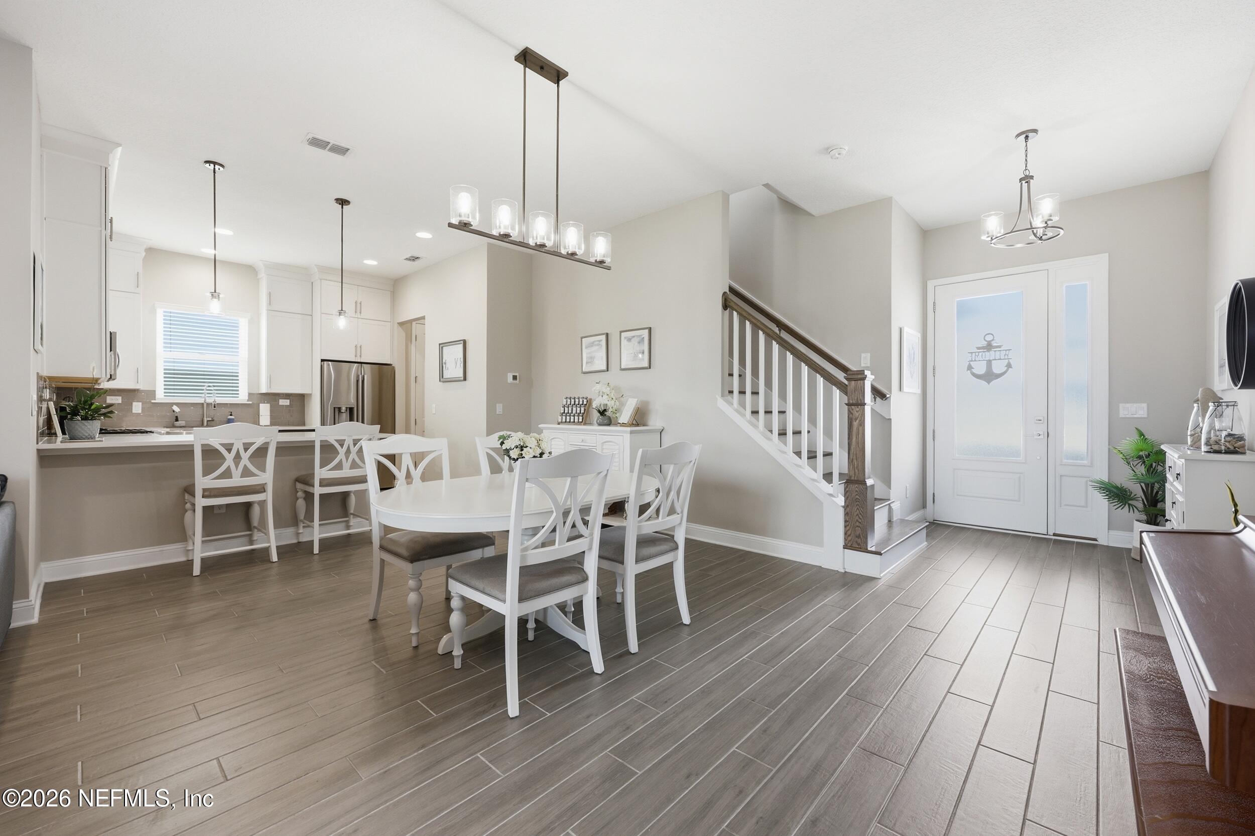 439 Rum Runner Way St. Johns, FL 32259 - Photo 8 of 82 a dining room with furniture a chandelier and wooden floor