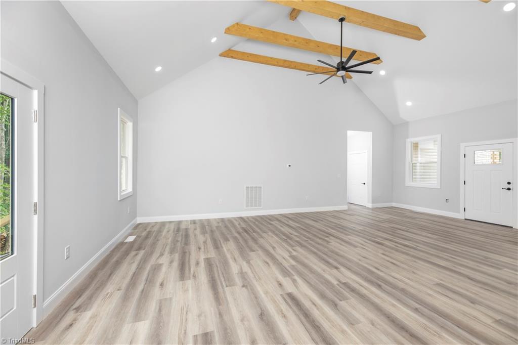 475 Timber Ridge Road Kernersville, NC 27284 - Photo 15 of 43 Open Living/Dining rooms: Beautiful cathedral ceiling with wooden beam accents.