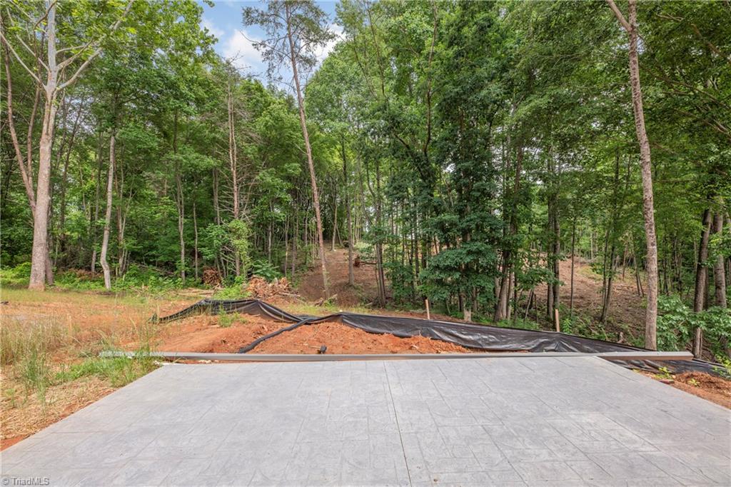 475 Timber Ridge Road Kernersville, NC 27284 - Photo 10 of 43 Since this pic, additional grading has been done. Nice view from patio.