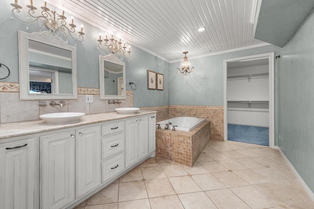 1929 Berkeley Place Fort Worth, TX 76110 - Photo 16 of 34 a spacious bathroom with a granite countertop sink a mirror and bathtub