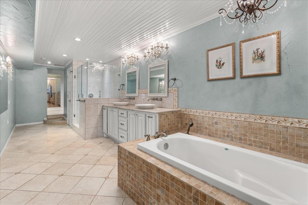 1929 Berkeley Place Fort Worth, TX 76110 - Photo 17 of 34 a spacious bathroom with a tub a double vanity sink and a mirror