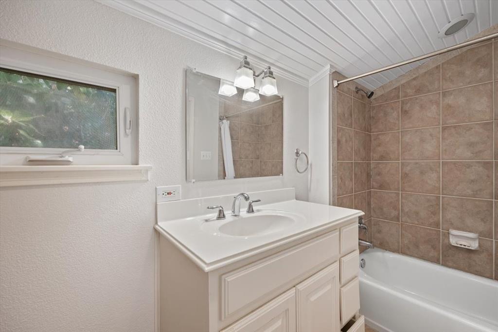 1929 Berkeley Place Fort Worth, TX 76110 - Photo 27 of 34 a bathroom with a sink and a mirror