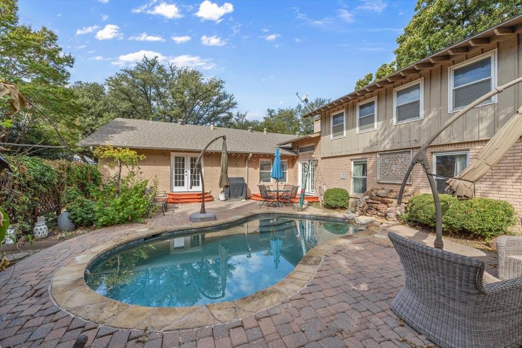 1929 Berkeley Place Fort Worth, TX 76110 - Photo 29 of 34 a view of a house with pool fire pit and chairs