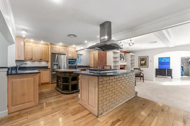 a large kitchen with a table and chairs