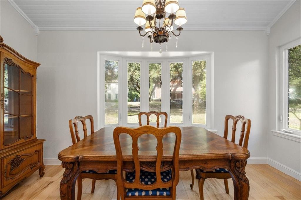 1929 Berkeley Place Fort Worth, TX 76110 - Photo 7 of 34 a view of a dining room with furniture a chandelier and wooden floor
