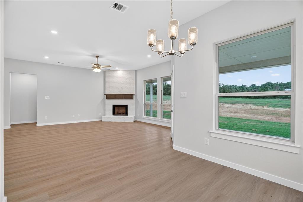 321 Skeen Peak Springtown, TX 76082 - Photo 16 of 37 Spacious open-concept interior featuring light wood-finish flooring and recessed lighting
