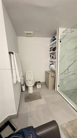 a bathroom with a sink a mirror and shower