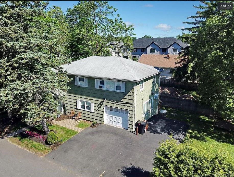 a view of a house with a garden and pathway