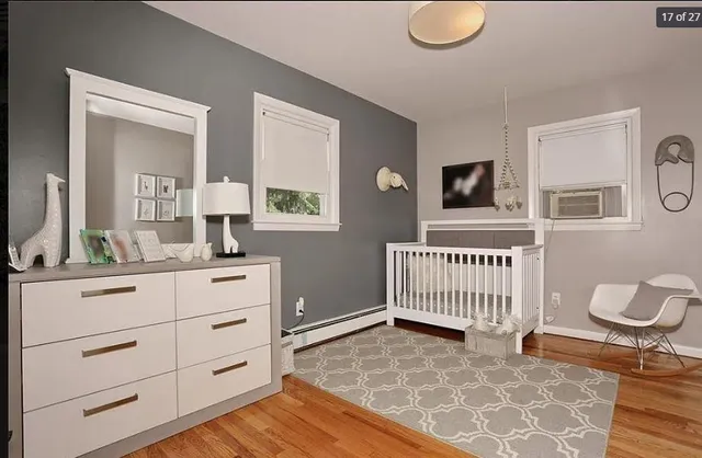 a bedroom with a bed and a mirror on the dresser