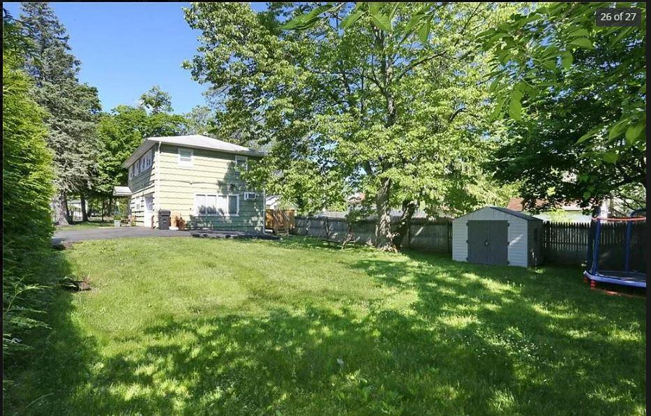 6 Schevchenko Place Spring Valley, NY 10977 - Photo 3 of 21 a view of a house with a yard and a tree