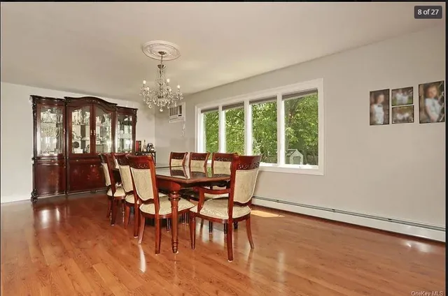 a view of a dining room with furniture window and wooden floor