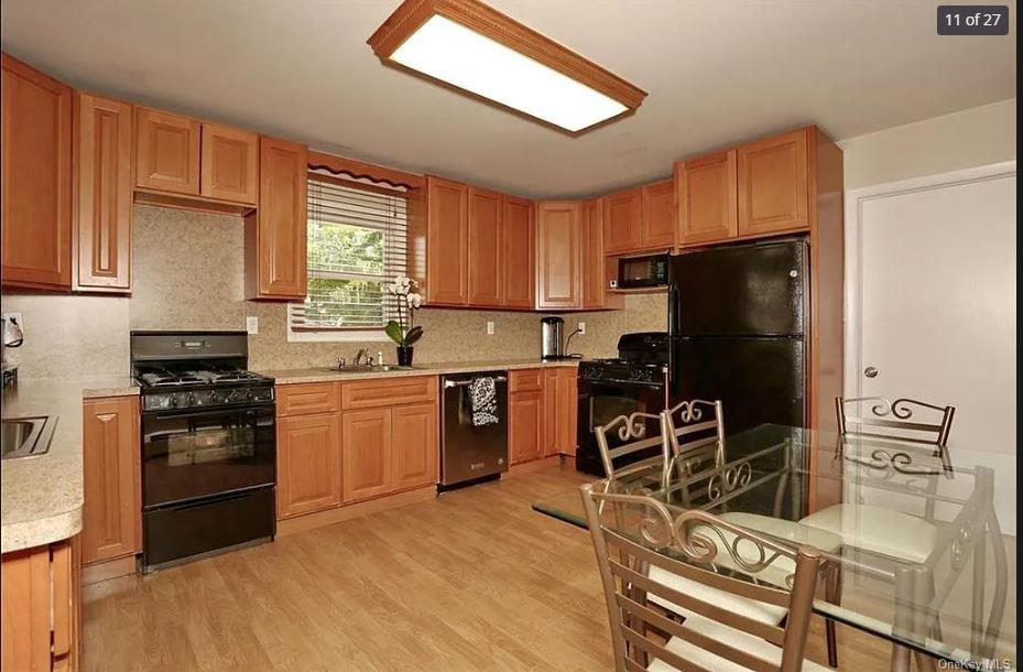 6 Schevchenko Place Spring Valley, NY 10977 - Photo 10 of 21 a kitchen with a refrigerator stove and microwave