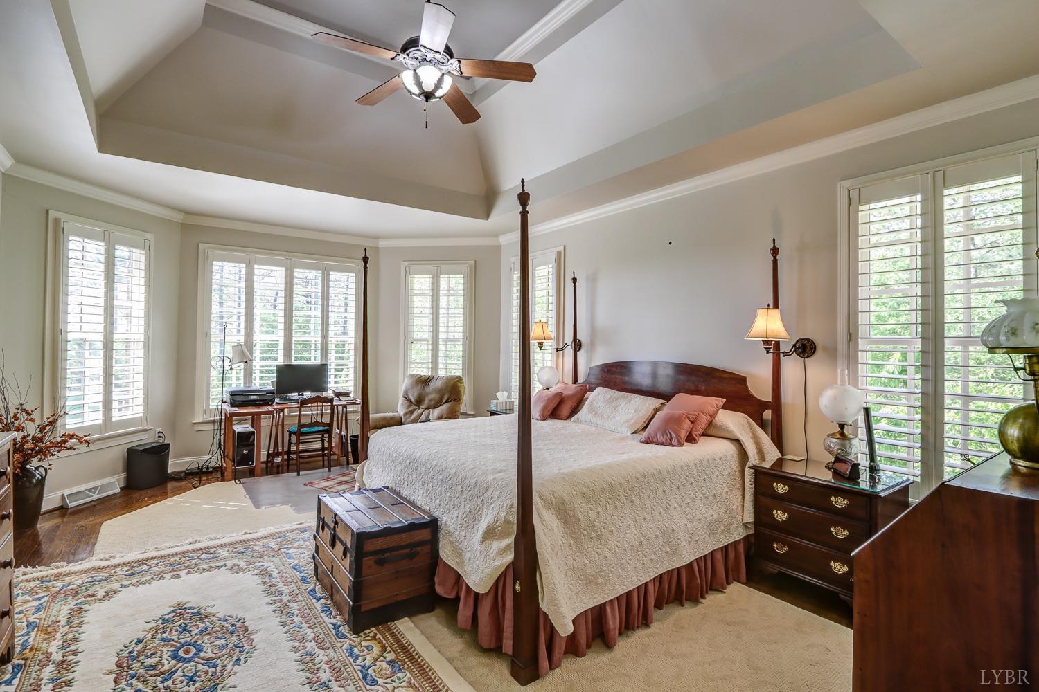107 Emory Way Amherst, VA 24521 - Photo 38 of 85 Main level primary bedroom with custom plantation blinds with gorgeous mountain views, natural light and pool view!