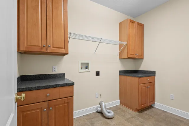 a kitchen with granite countertop cabinets and black appliances
