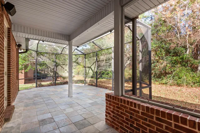 a view of a porch with chairs and backyard