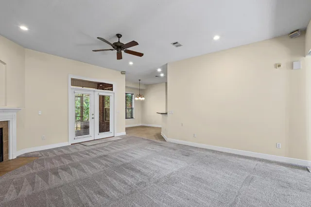 a view of a livingroom with a ceiling fan and window