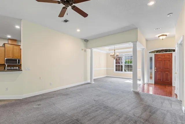 a view of a livingroom with a ceiling fan and window