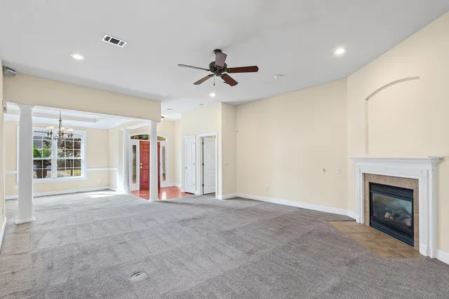 a view of an empty room with a fireplace