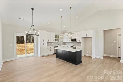 a kitchen with stainless steel appliances granite countertop a stove and a refrigerator
