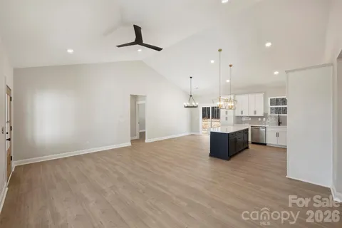 a large kitchen with kitchen island a sink stainless steel appliances and cabinets