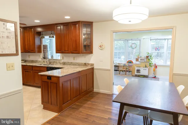 a kitchen with kitchen island granite countertop wooden cabinets and a counter top space
