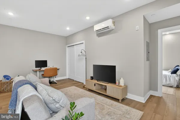 a bedroom with furniture and a flat screen tv