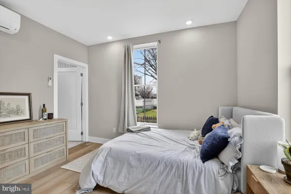 a bedroom with a bed and a window