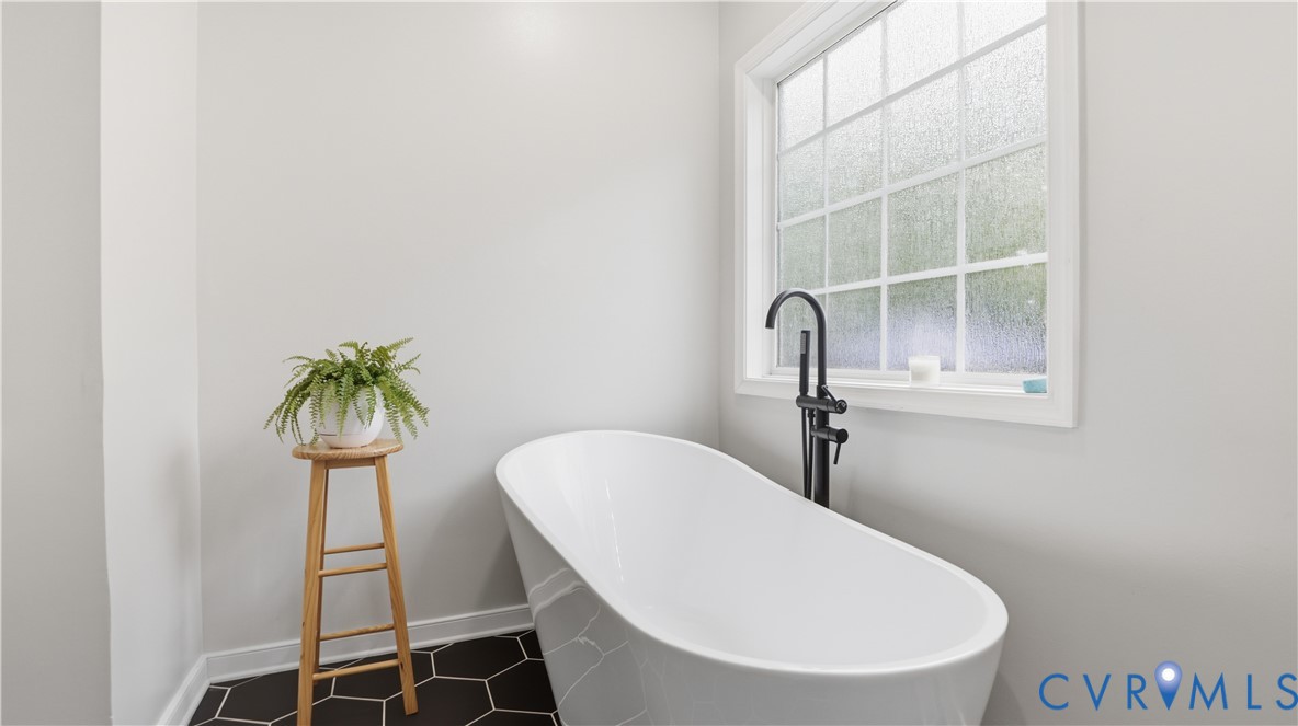 2406 Emanuel Church Road Powhatan, VA 23139 - Photo 26 of 48 White freestanding bathtub with a contemporary mat
