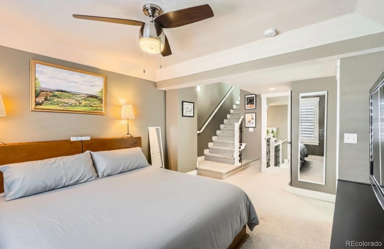 1145 South Logan Street Denver, CO 80210 - Photo 14 of 21 a bedroom with a large bed and a chandelier