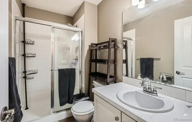 a bathroom with a sink toilet and shower