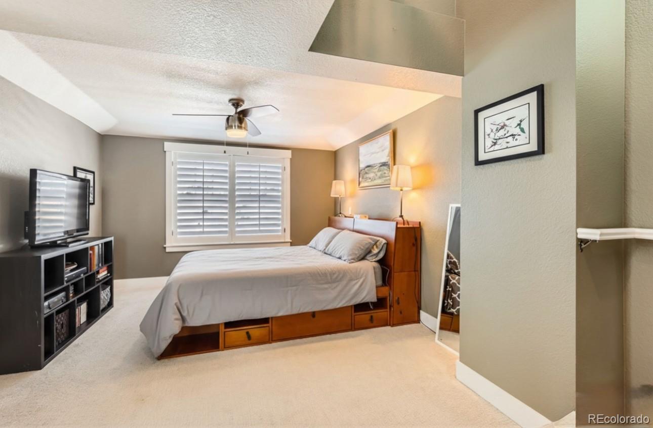 1145 South Logan Street Denver, CO 80210 - Photo 15 of 21 a bedroom with a bed and a flat tv screen on the dresser