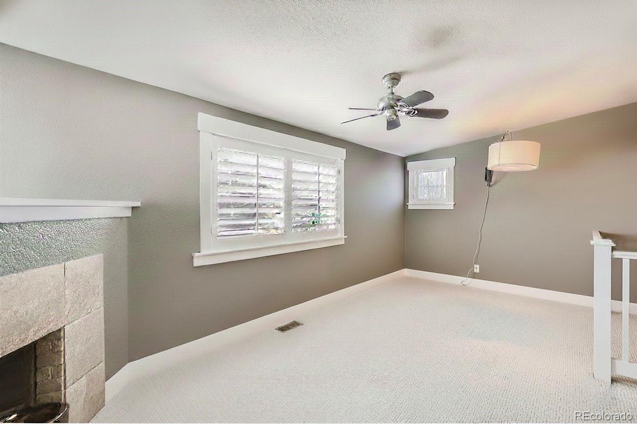 1145 South Logan Street Denver, CO 80210 - Photo 16 of 21 a bedroom with a bed and a chandelier