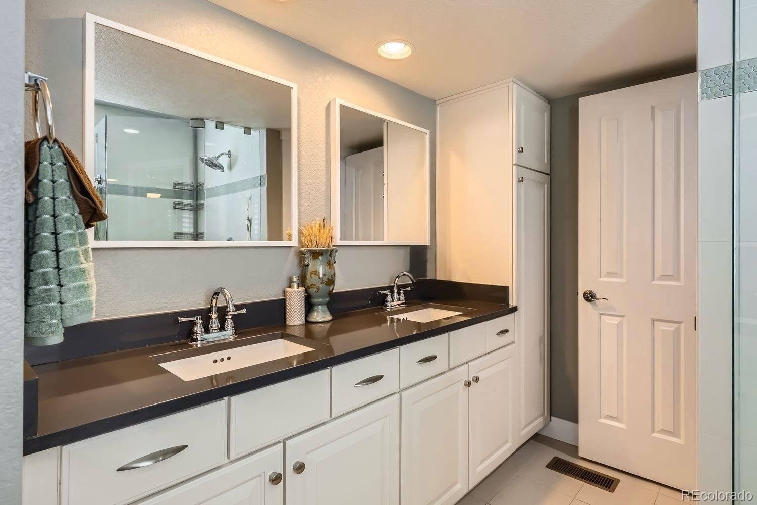 1145 South Logan Street Denver, CO 80210 - Photo 17 of 21 a bathroom with double sink and a mirror