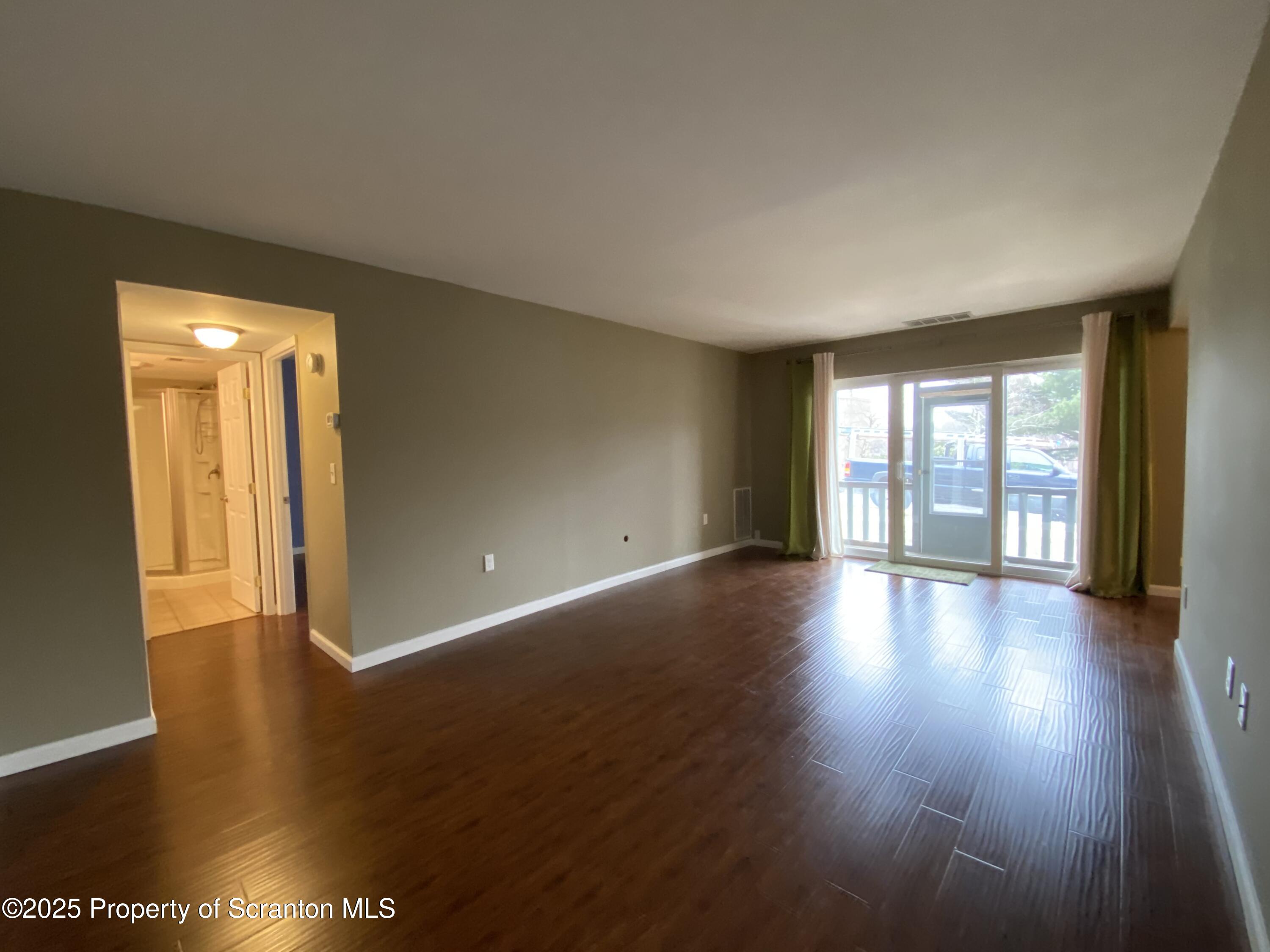 1702 Summit Pointe Scranton, PA 18508 - Photo 12 of 29 a view of an empty room with wooden floor and a window