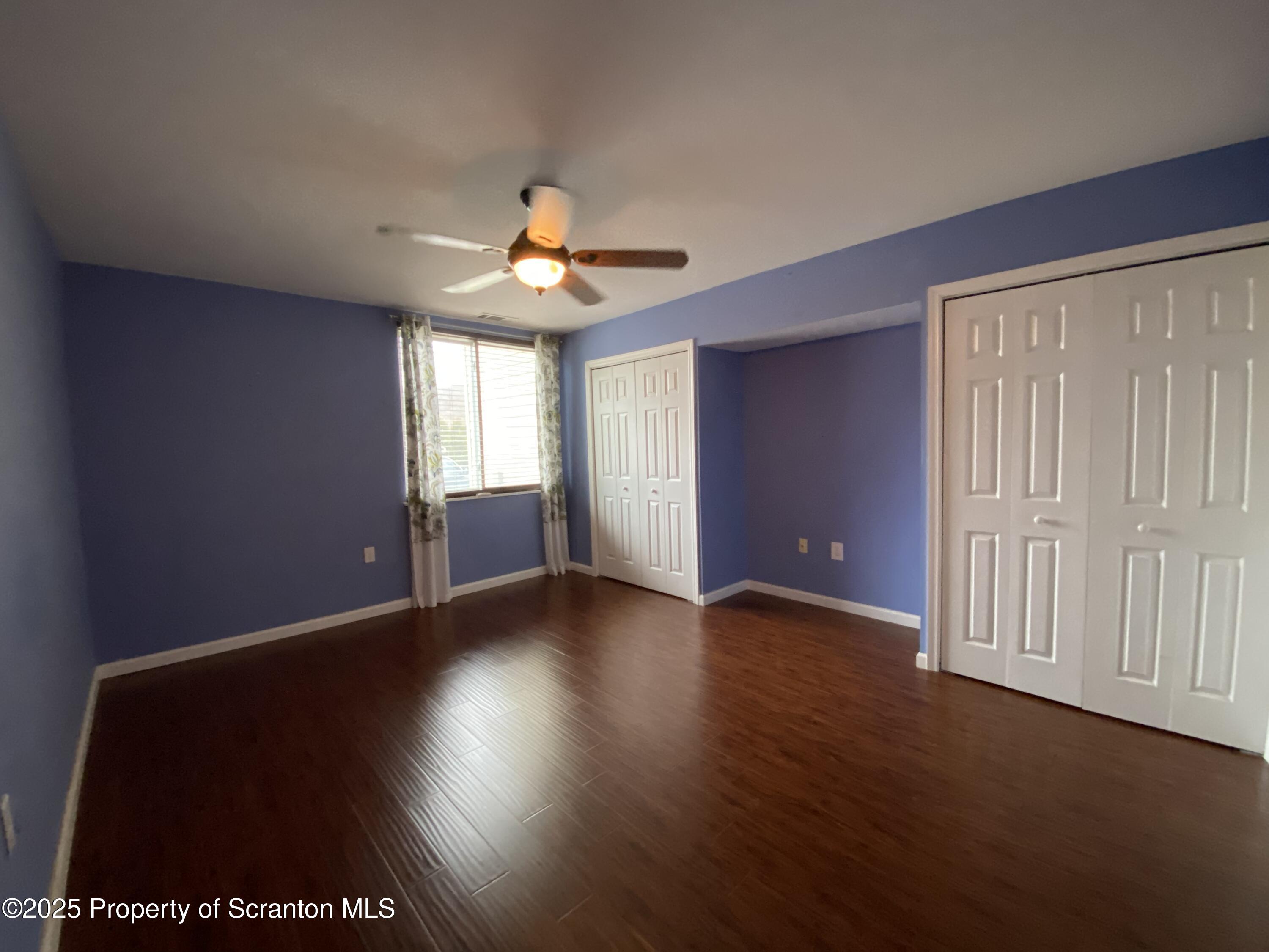 1702 Summit Pointe Scranton, PA 18508 - Photo 19 of 29 an empty room with wooden floor and windows