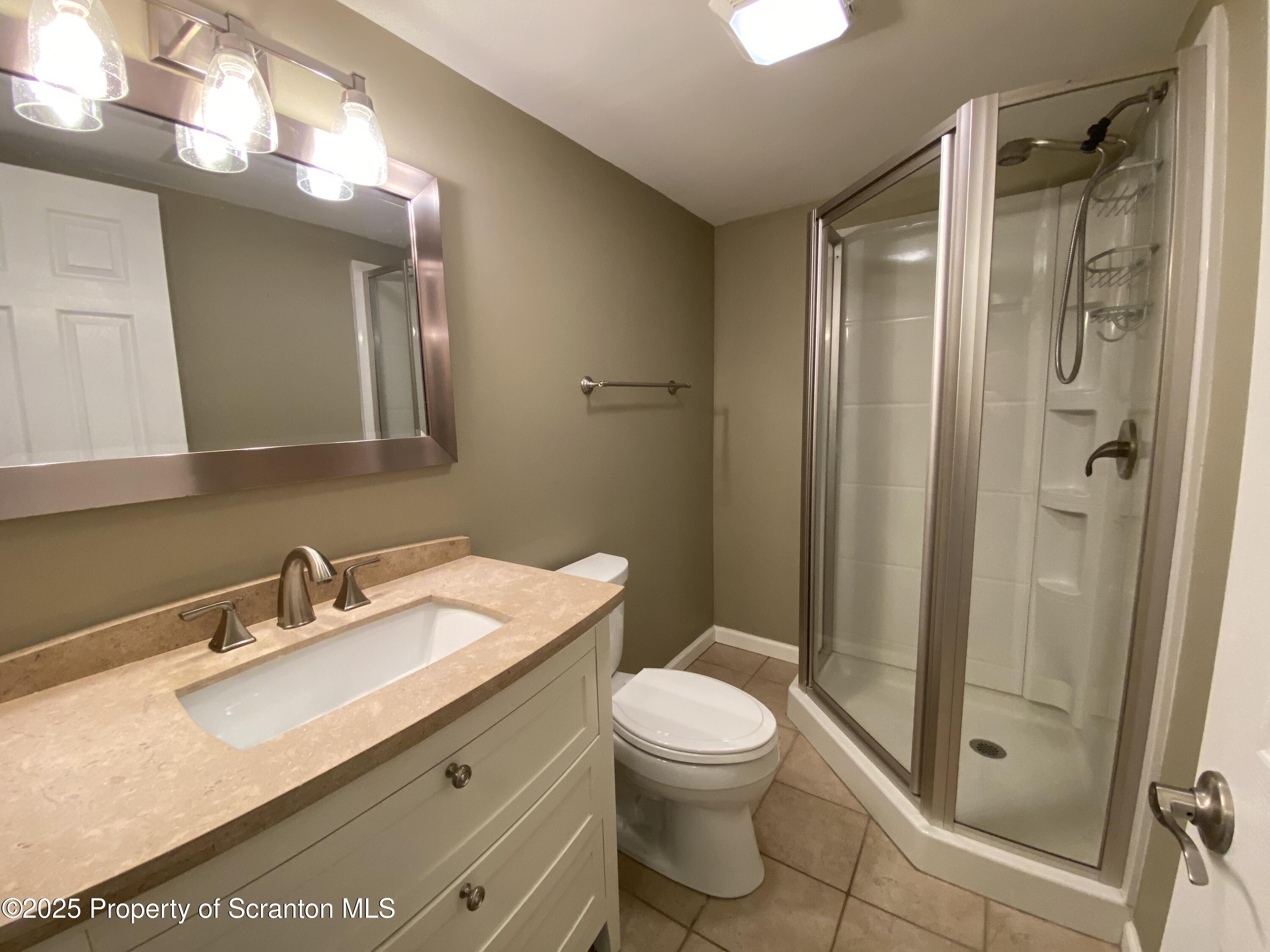 1702 Summit Pointe Scranton, PA 18508 - Photo 23 of 29 a bathroom with a sink toilet and shower