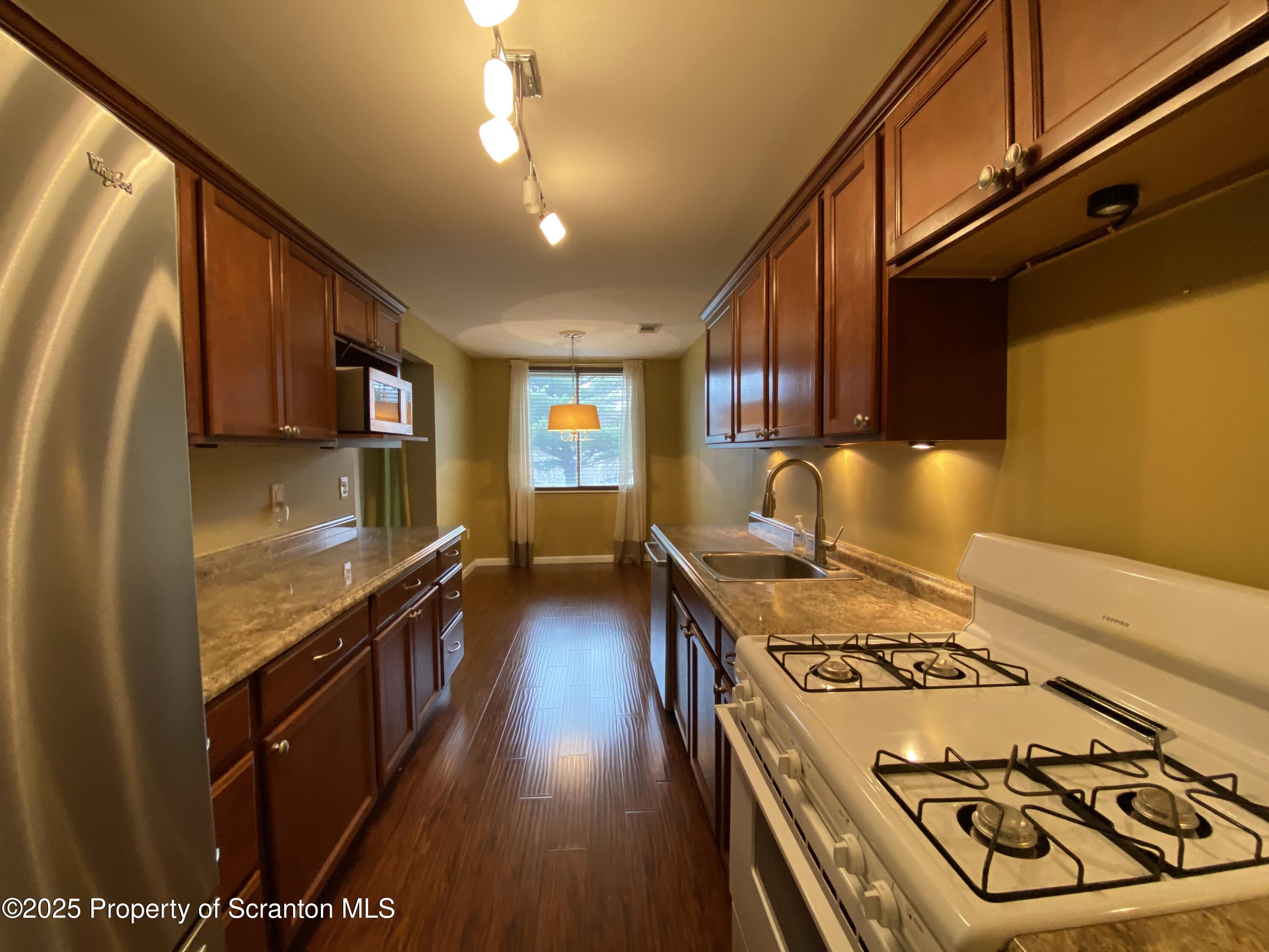 1702 Summit Pointe Scranton, PA 18508 - Photo 6 of 29 a kitchen with a stove and a wooden floors