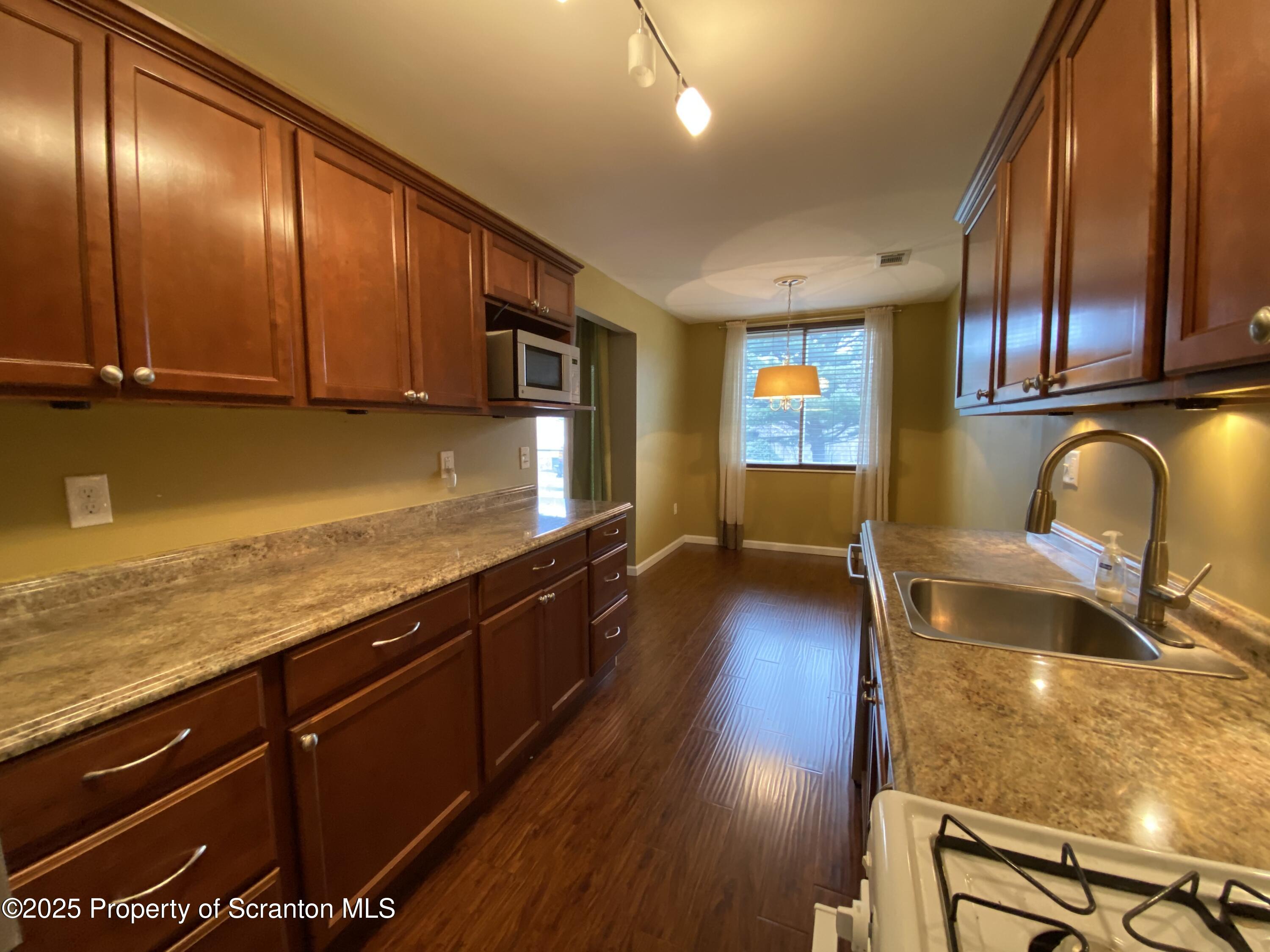1702 Summit Pointe Scranton, PA 18508 - Photo 7 of 29 a view of a kitchen with wooden floor and staircase