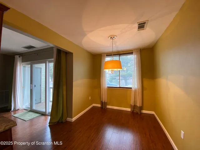 a view of livingroom with hardwood floor and front door