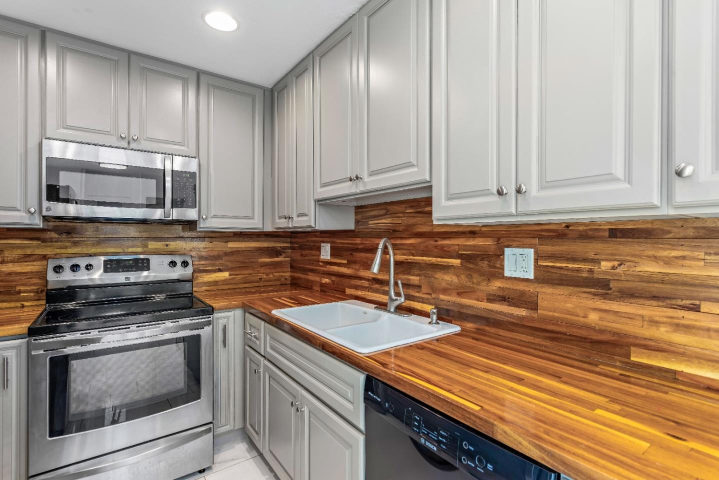 5510 Armitos Avenue, Unit 4 Goleta, CA 93117 - Photo 14 of 23 a kitchen with stainless steel appliances granite countertop a sink a stove and cabinets