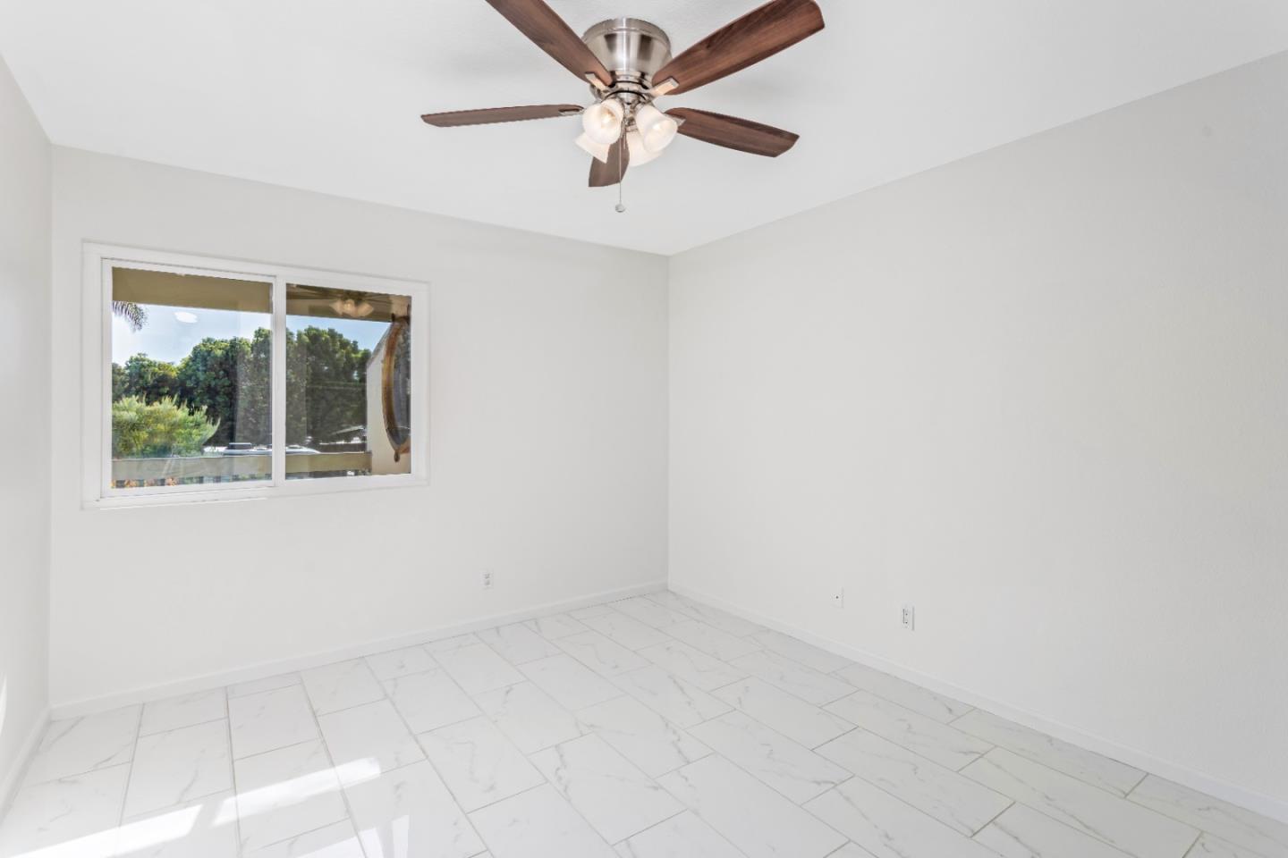5510 Armitos Avenue, Unit 4 Goleta, CA 93117 - Photo 19 of 23 an empty room with a window and a fan