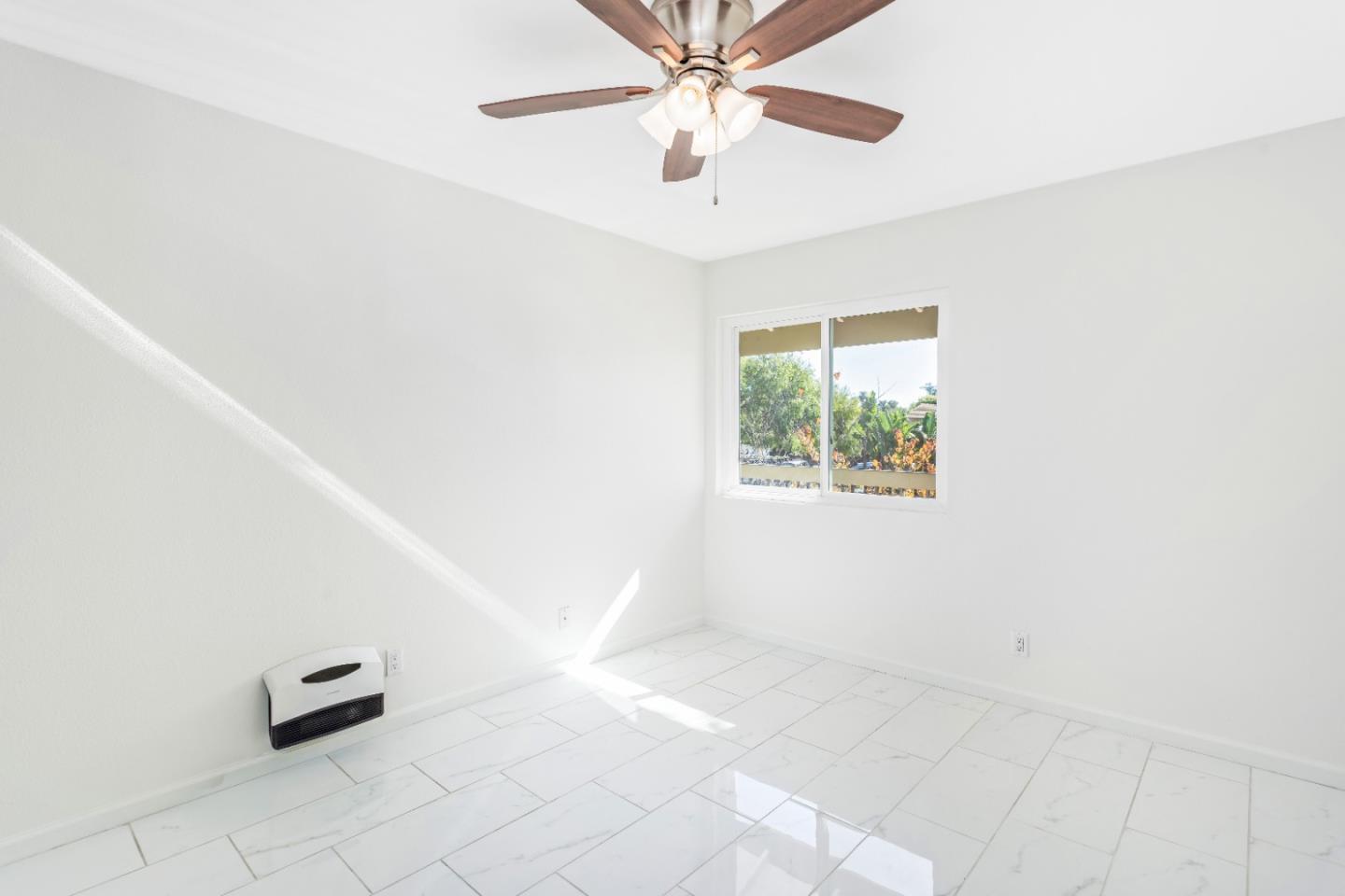 5510 Armitos Avenue, Unit 4 Goleta, CA 93117 - Photo 21 of 23 an empty room with windows and ceiling fan