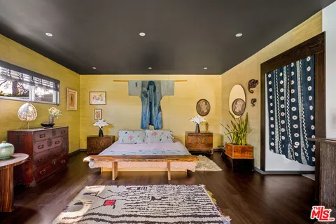 a spacious bathroom with a tub shower and mirror