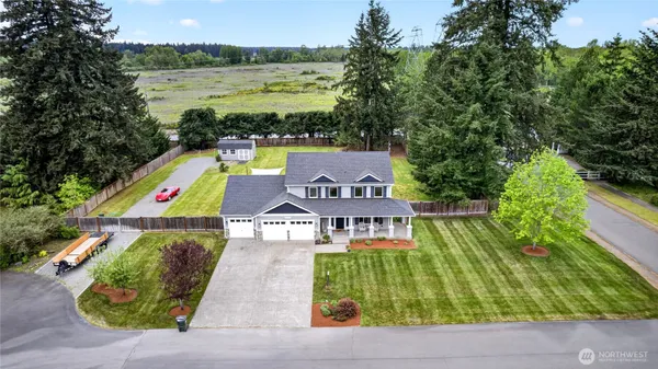 an aerial view of a house with outdoor space swimming pool and mountains in the background