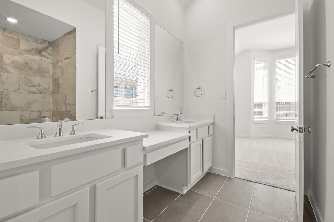 16538 Mandora Lane Conroe, TX 77302 - Photo 13 of 22 a bathroom with a sink double vanity and a mirror