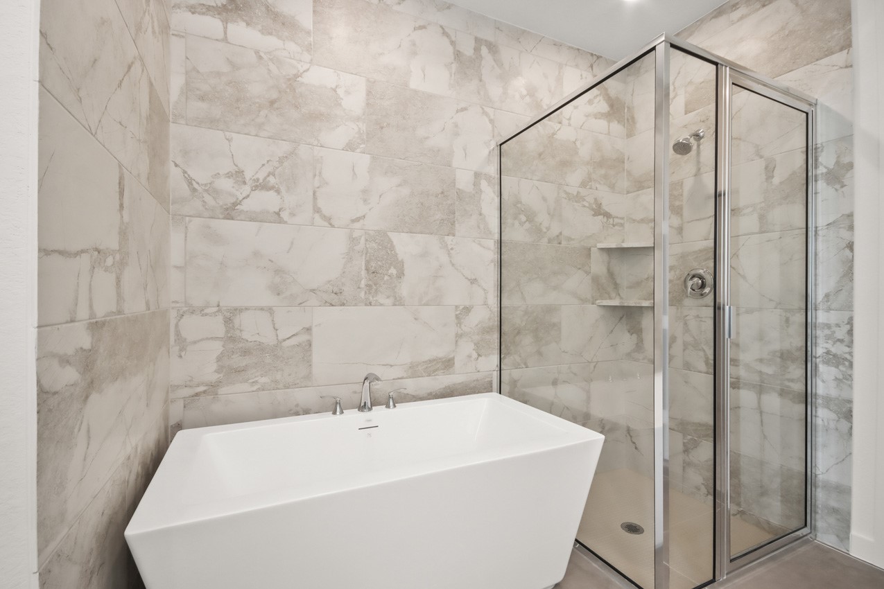 16538 Mandora Lane Conroe, TX 77302 - Photo 14 of 22 a bathroom with a white bath tub and shower