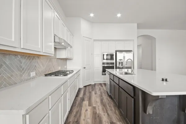 a kitchen with cabinets and stainless steel appliances
