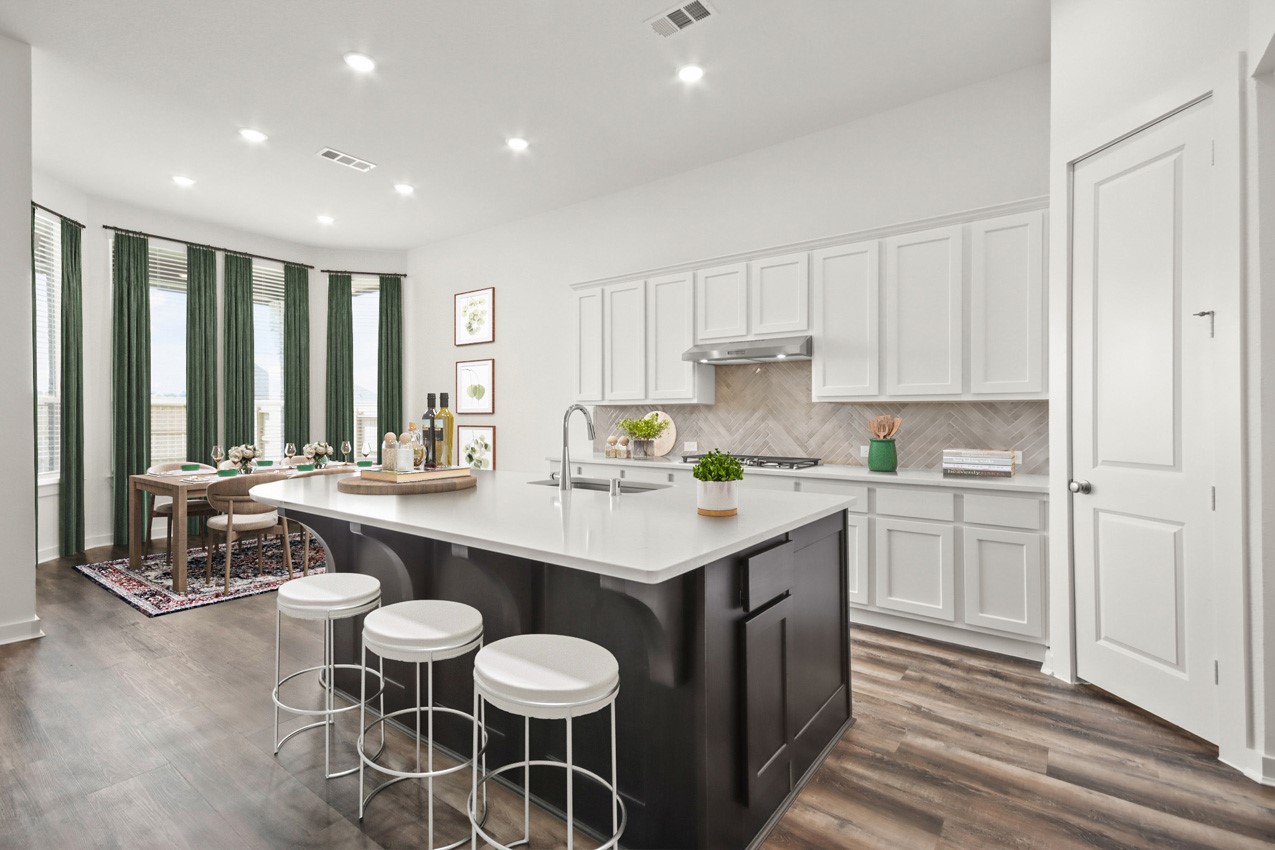 16538 Mandora Lane Conroe, TX 77302 - Photo 4 of 22 a kitchen with a sink and chairs