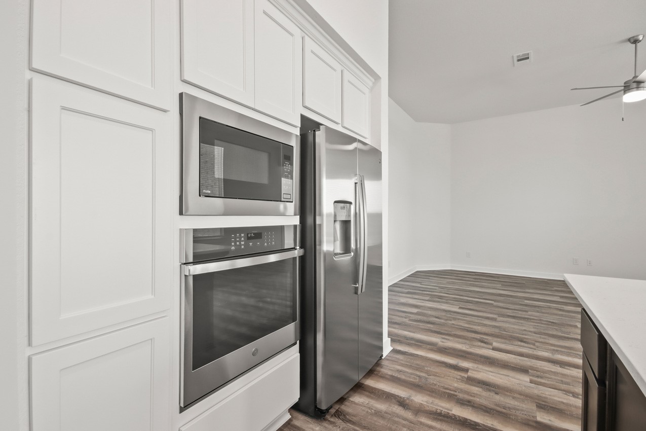 16538 Mandora Lane Conroe, TX 77302 - Photo 5 of 22 a kitchen with cabinets and stainless steel appliances