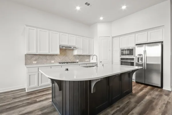 a view of kitchen with wooden floor electronic appliances and window